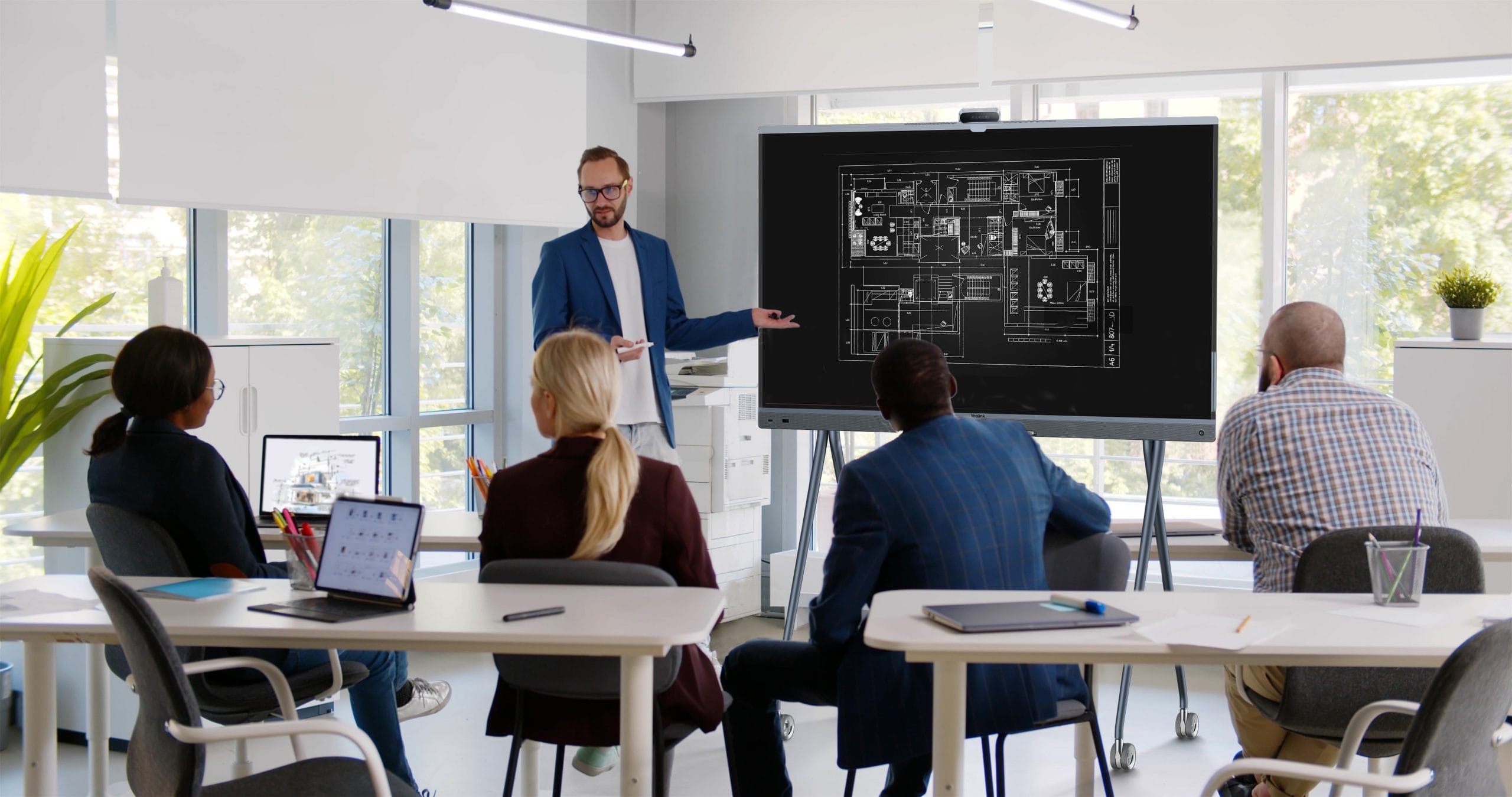 An employee presenting ideas on the Yealink MeetingBoard Pro
