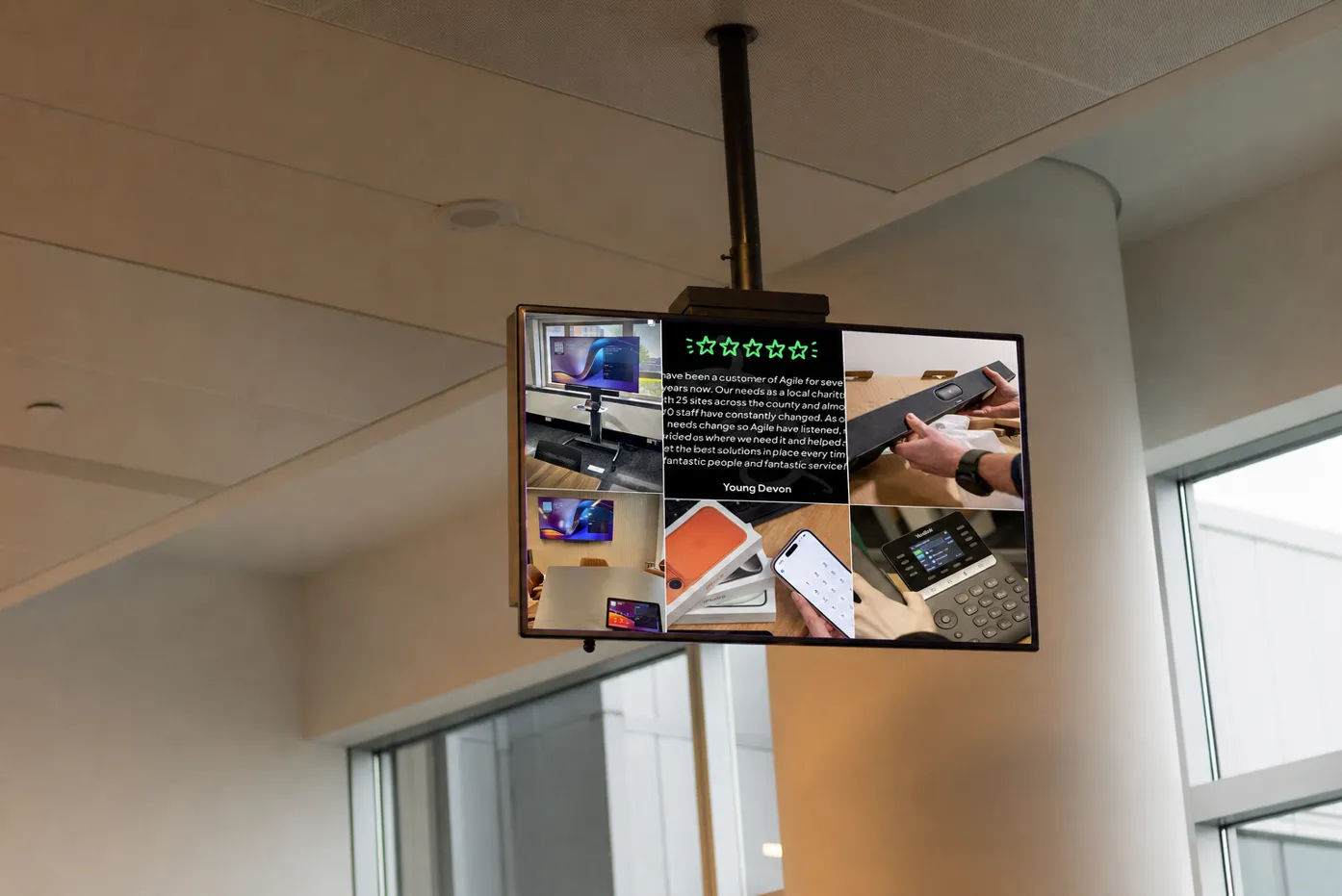A mockup of a digital signage display with a range of social media posts displayed on it